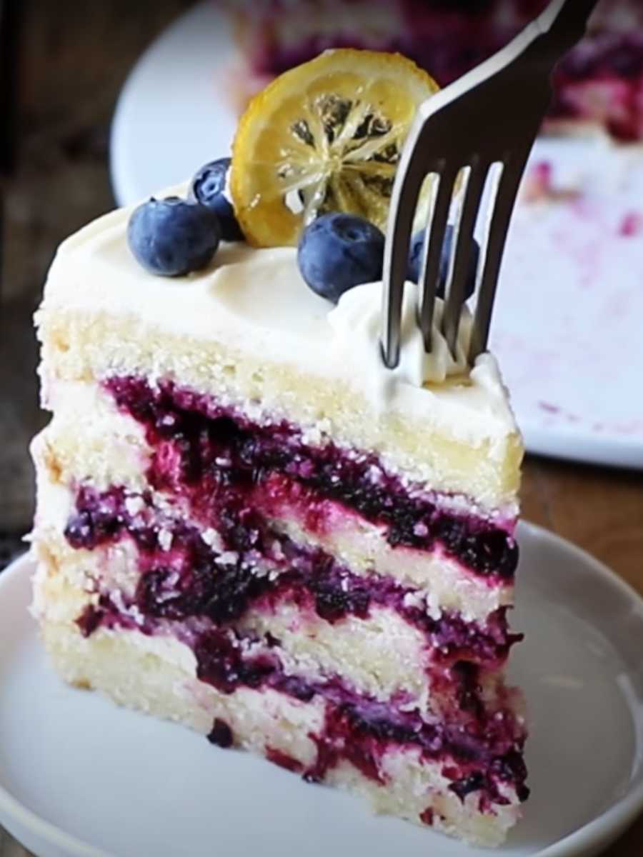 Blueberry Lemon Cake! A perfect blend of zesty lemon, sweet blueberries, and a luscious lemon creme topping. Elevate your dessert experience!